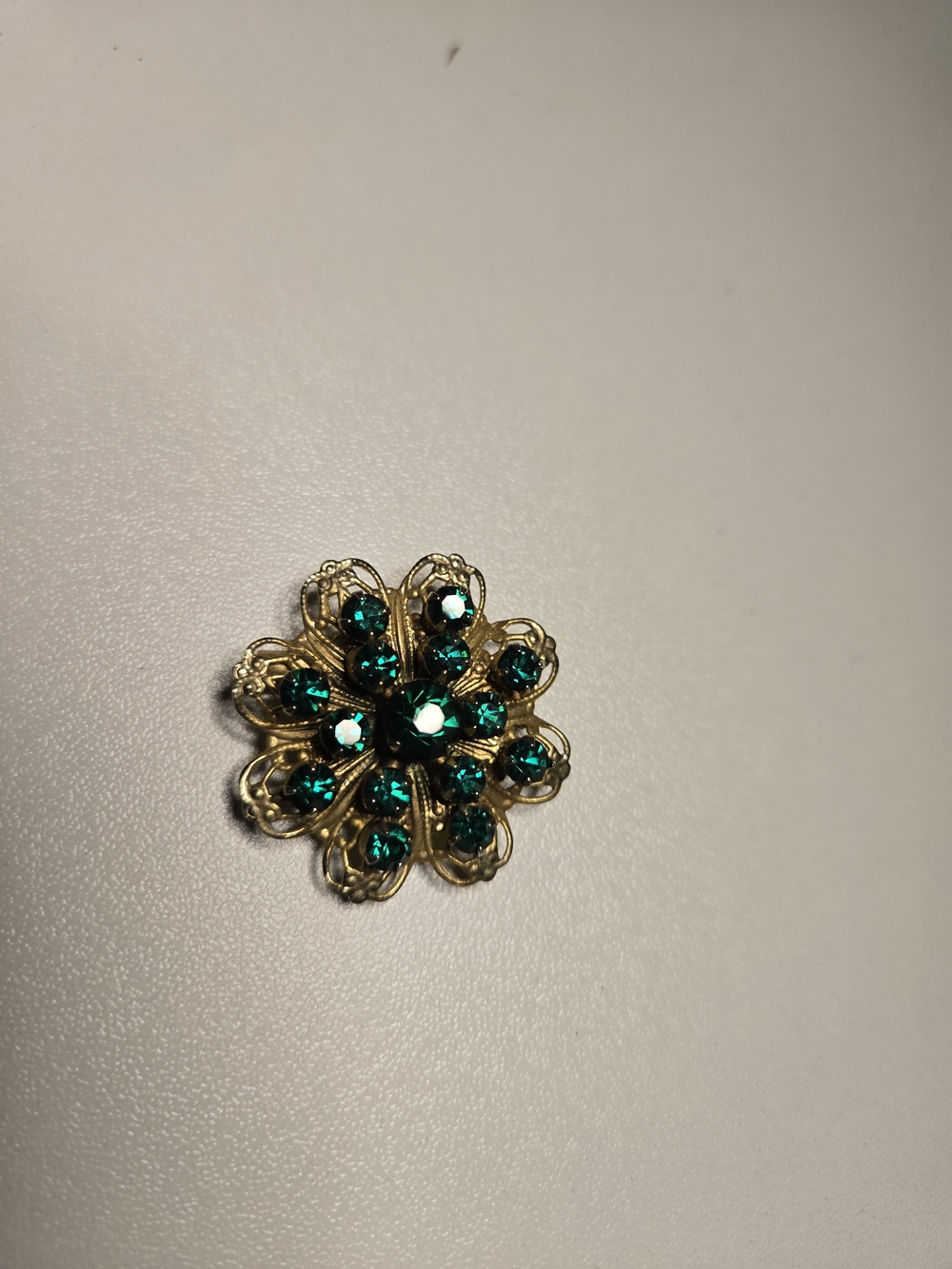 Gold-Tone Floral Brooch with Emerald Green Crystals